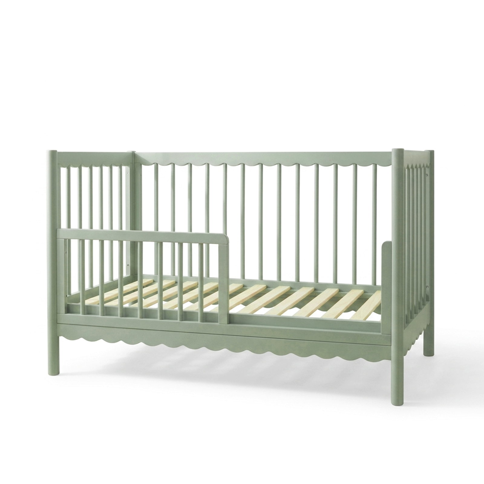 Sage green convertible crib on white background