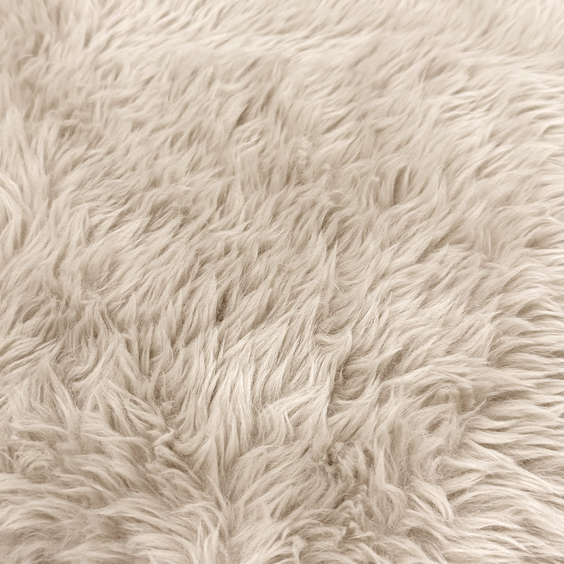Close-up of light beige plush faux fur texture
