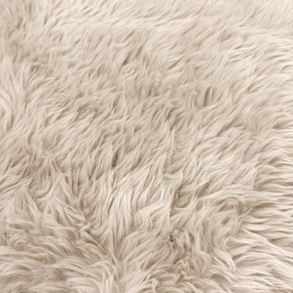 Close-up of light beige plush faux fur texture