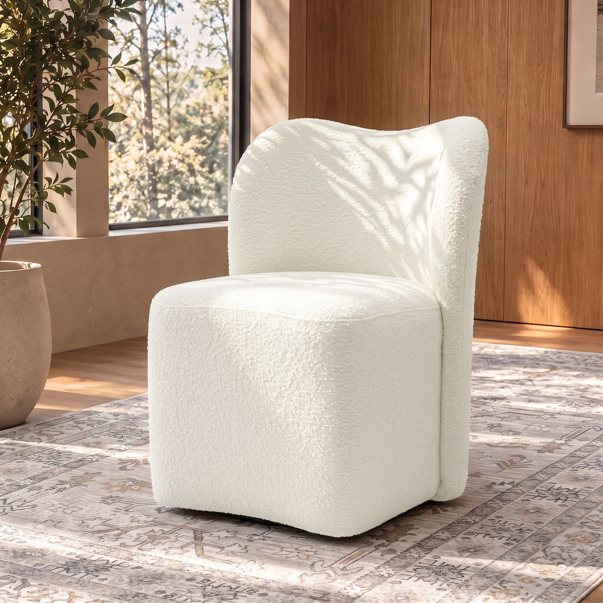 White boucle accent chair in a stylish room with rug and windows