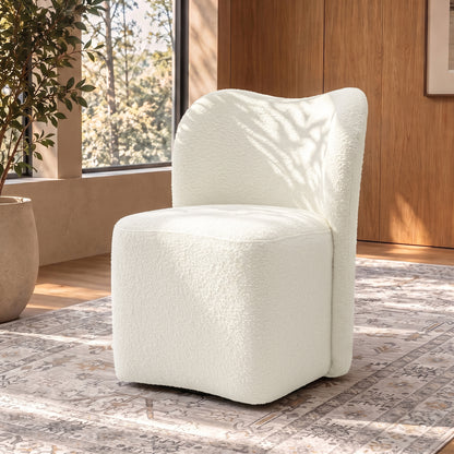 White boucle accent chair in a stylish room with rug and windows