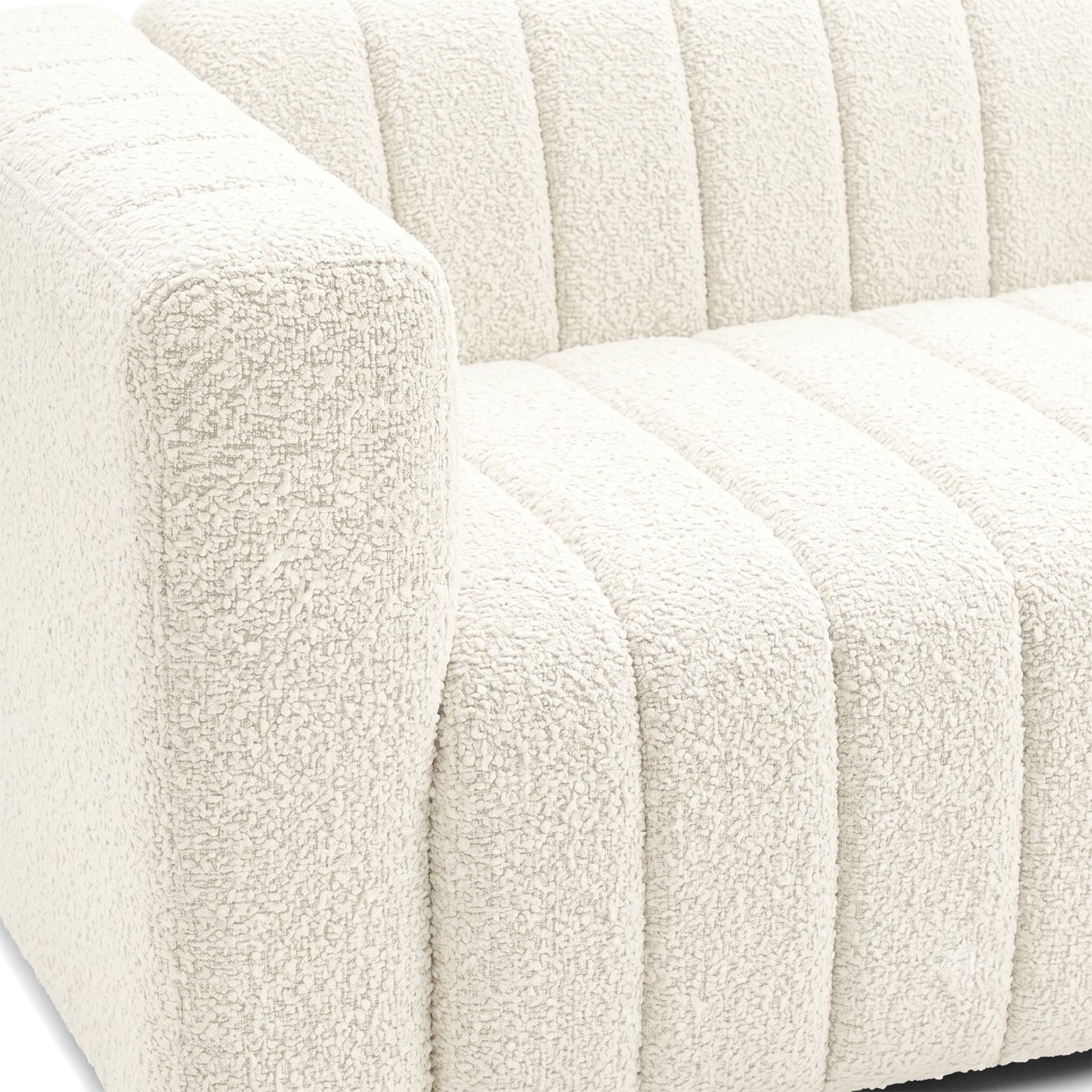 Close-up of the left side and seat of a cream textured sofa