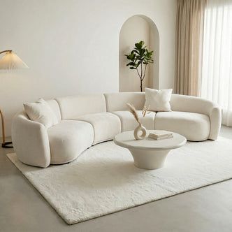 Sectional sofa in a modern living room with coffee table and lamp