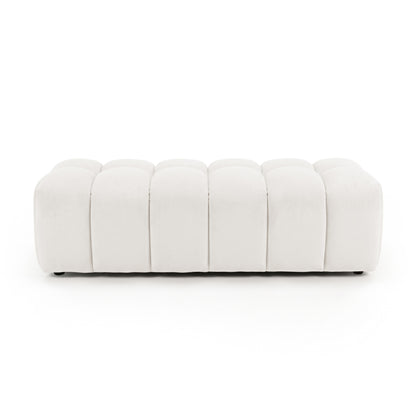 Light beige upholstered panel-tufted ottoman bench on a white background