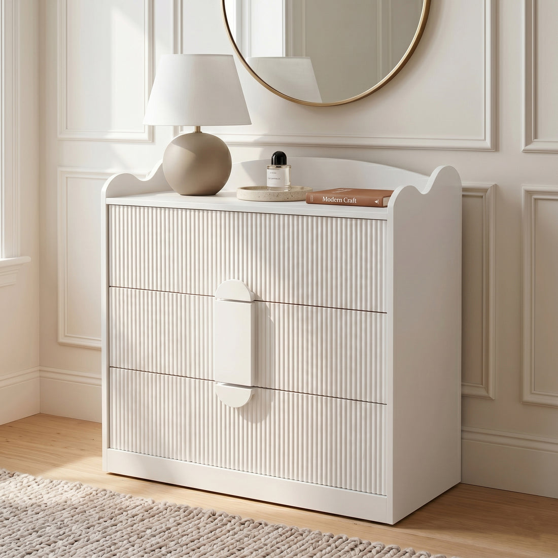White three-drawer dresser in a modern room with decorative objects