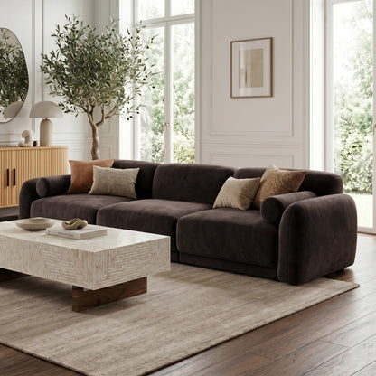 Dark brown sectional sofa in styled living room with natural light and decor