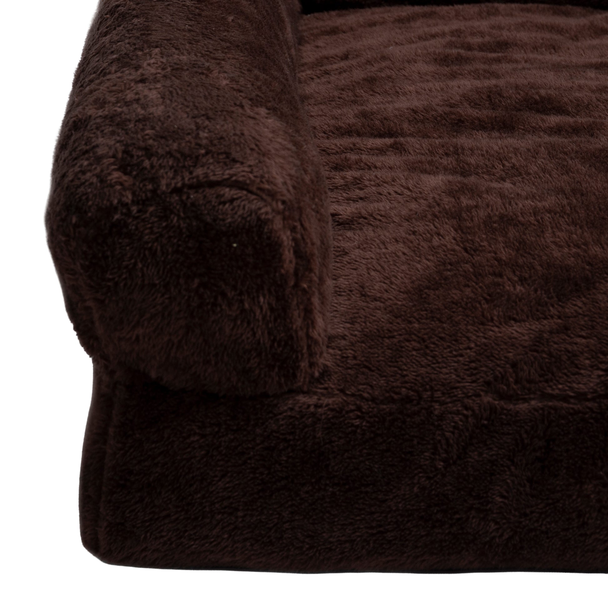 Close-up of dark brown plush bed corner on white background