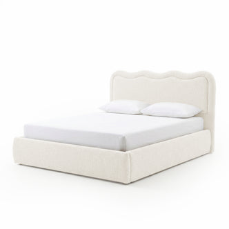 Modern upholstered bed with pillows on white background