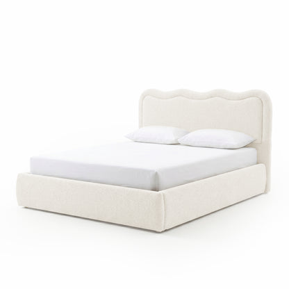 Modern upholstered bed with pillows on white background