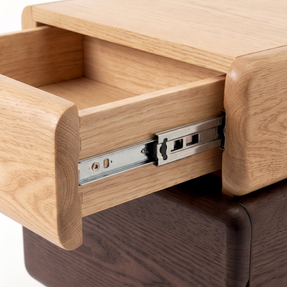 Close-up of a partially open wooden drawer showing craftsmanship and metal slide on a white background