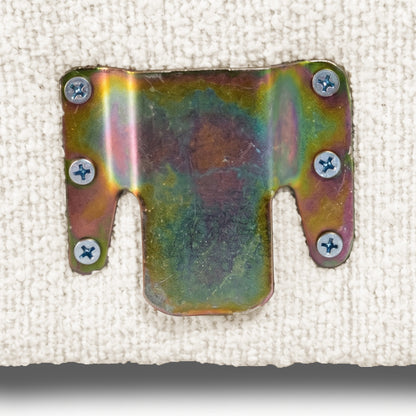 Close-up of rainbow-finish metal mounting bracket attached to off-white fabric