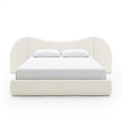 Off-white upholstered bed with curved headboard on white background