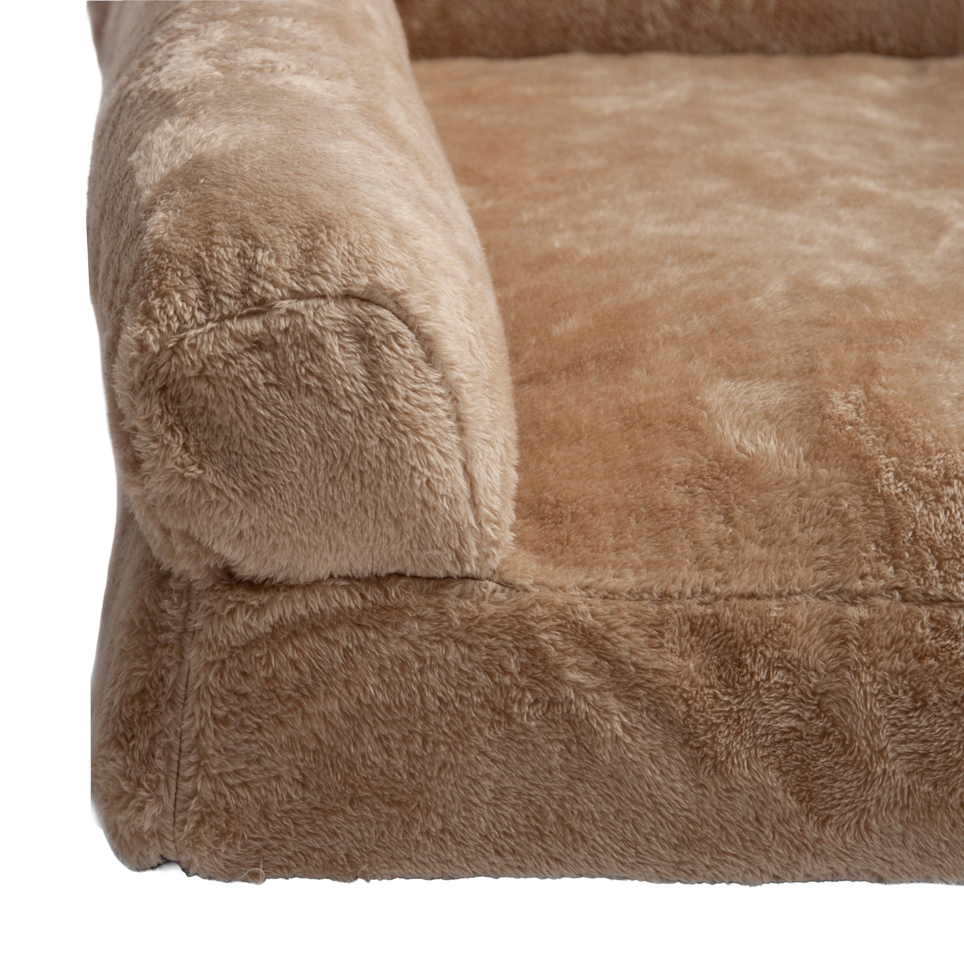 Close-up of plush tan bed corner and stitching on white background