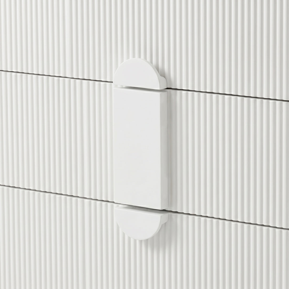 Close-up of white geometric drawer handle on ribbed surface