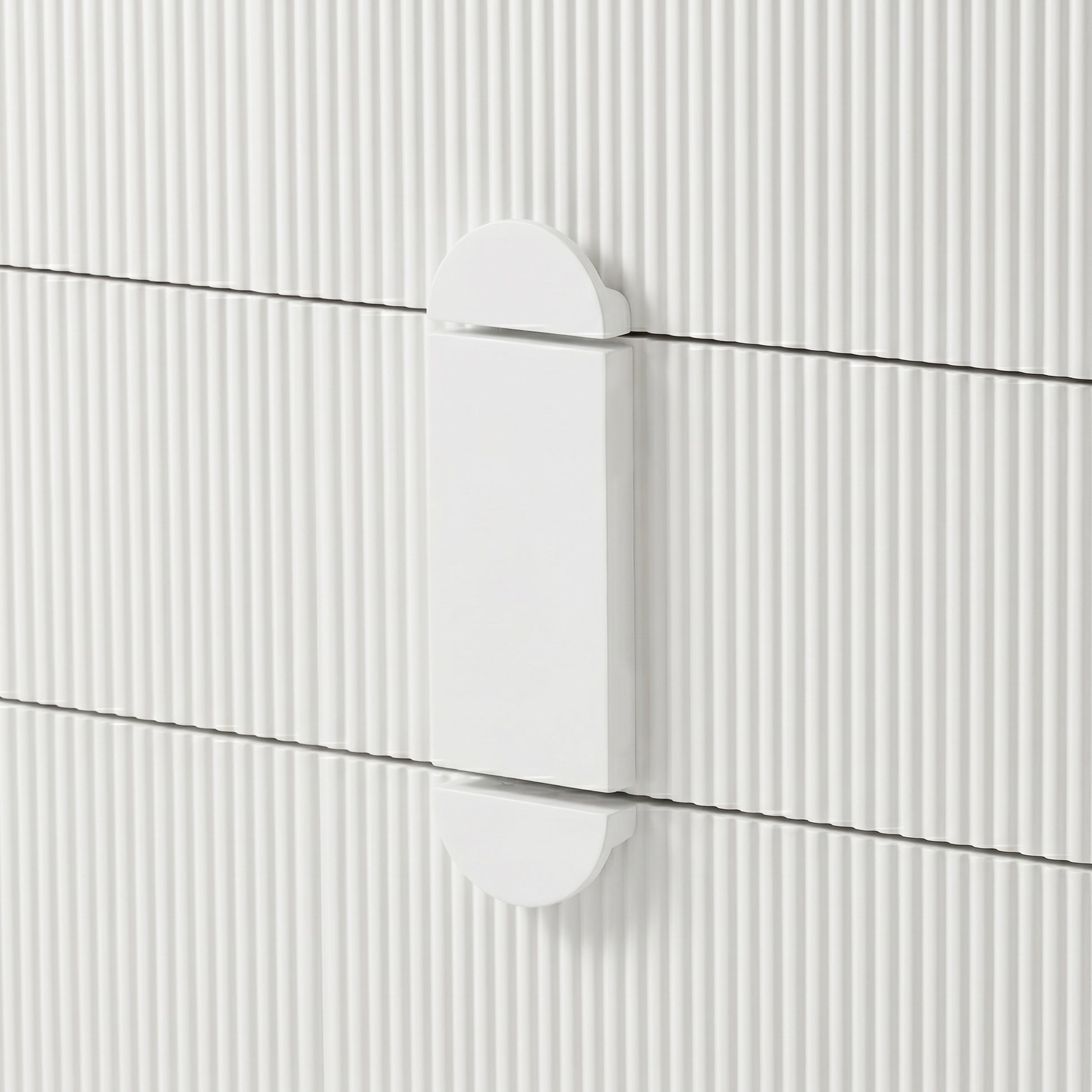 Close-up of white geometric drawer handle on ribbed surface