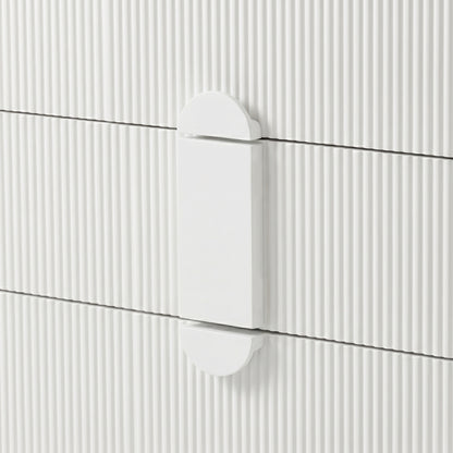 Close-up of white geometric drawer handle on ribbed surface