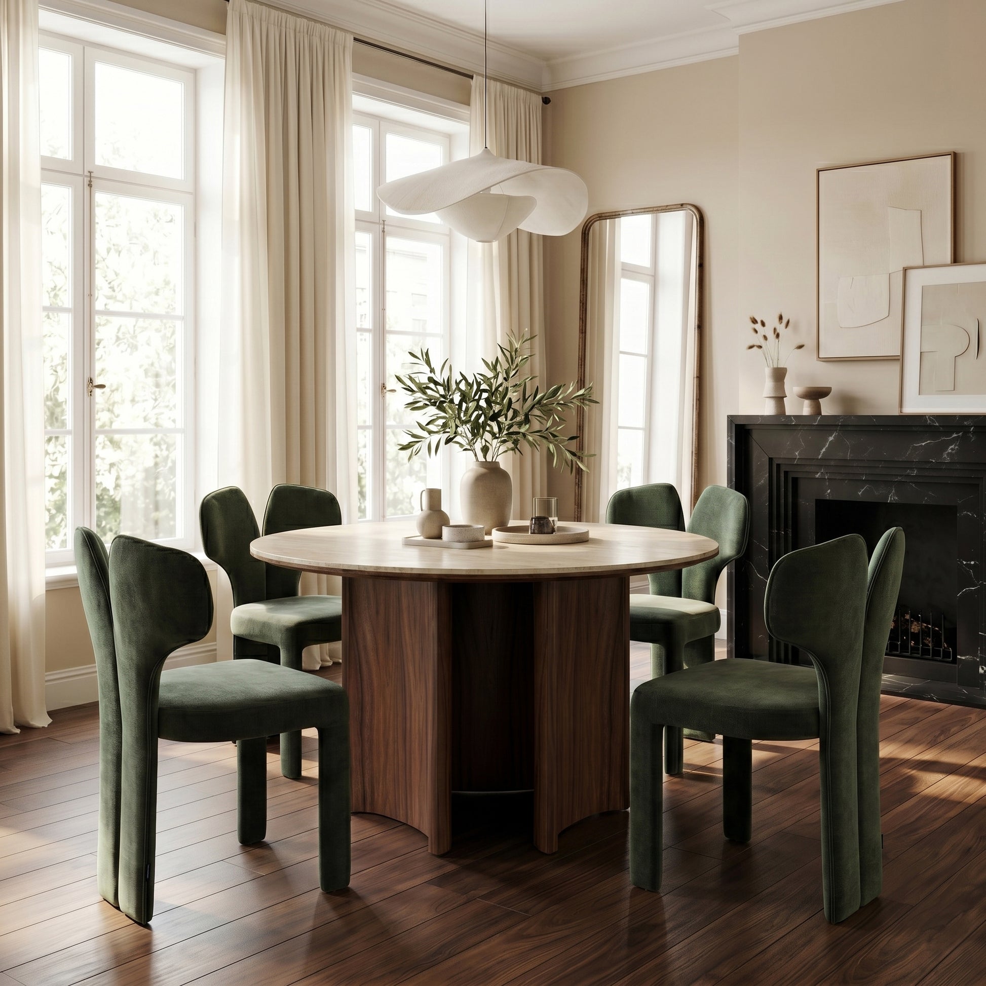 Round dining table with green velvet chairs in a stylish dining room