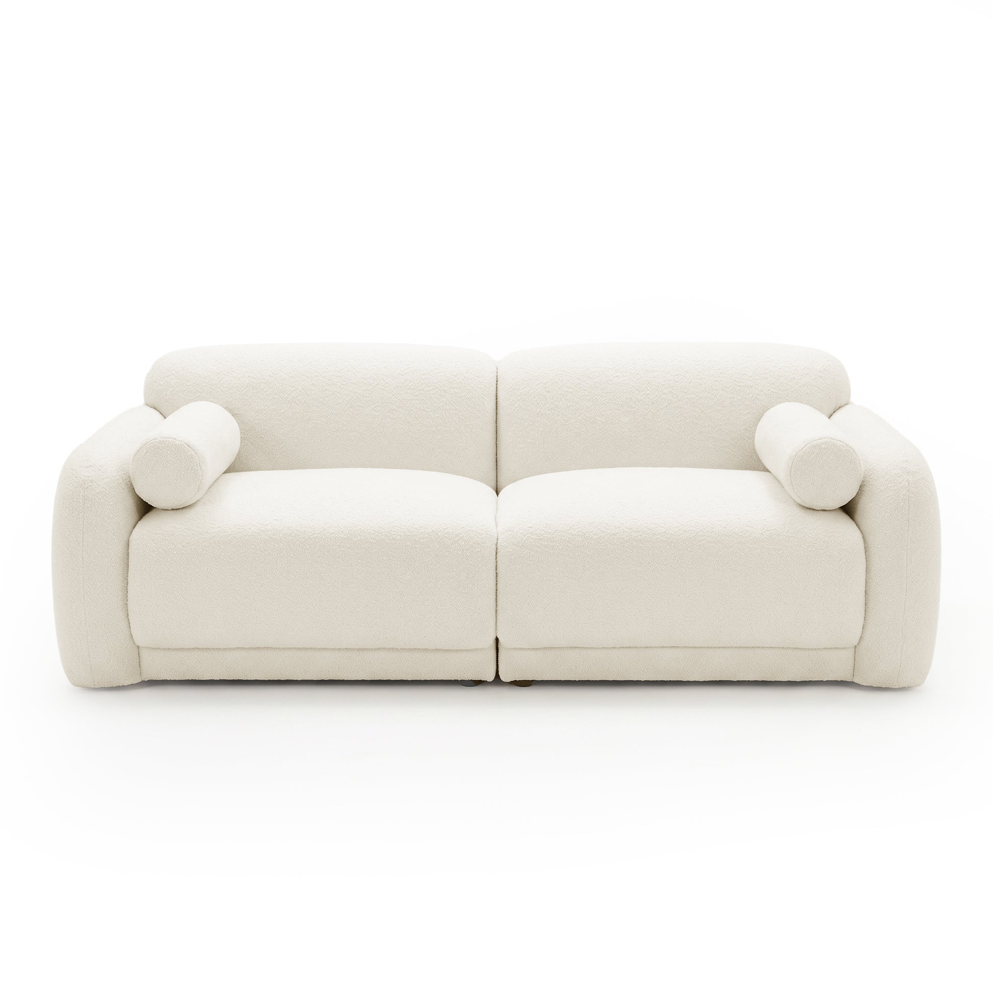Off-white sofa with rounded arms and cylindrical cushions on white background