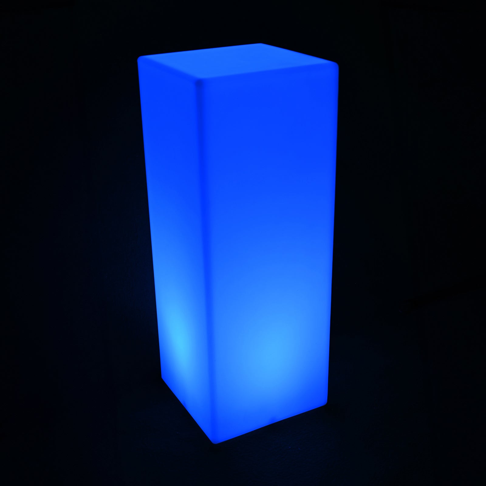 Colour Changing LED Column Light Indoor & Outdoor, a minimalist rectangular prism, emits a bright blue glow. Perfect for creating ambiance with 16 color options and versatile indoor-outdoor use.