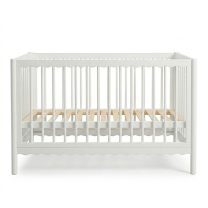 White crib with natural wood slats on a white background