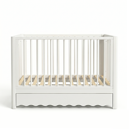 White wooden crib with storage drawer on white background