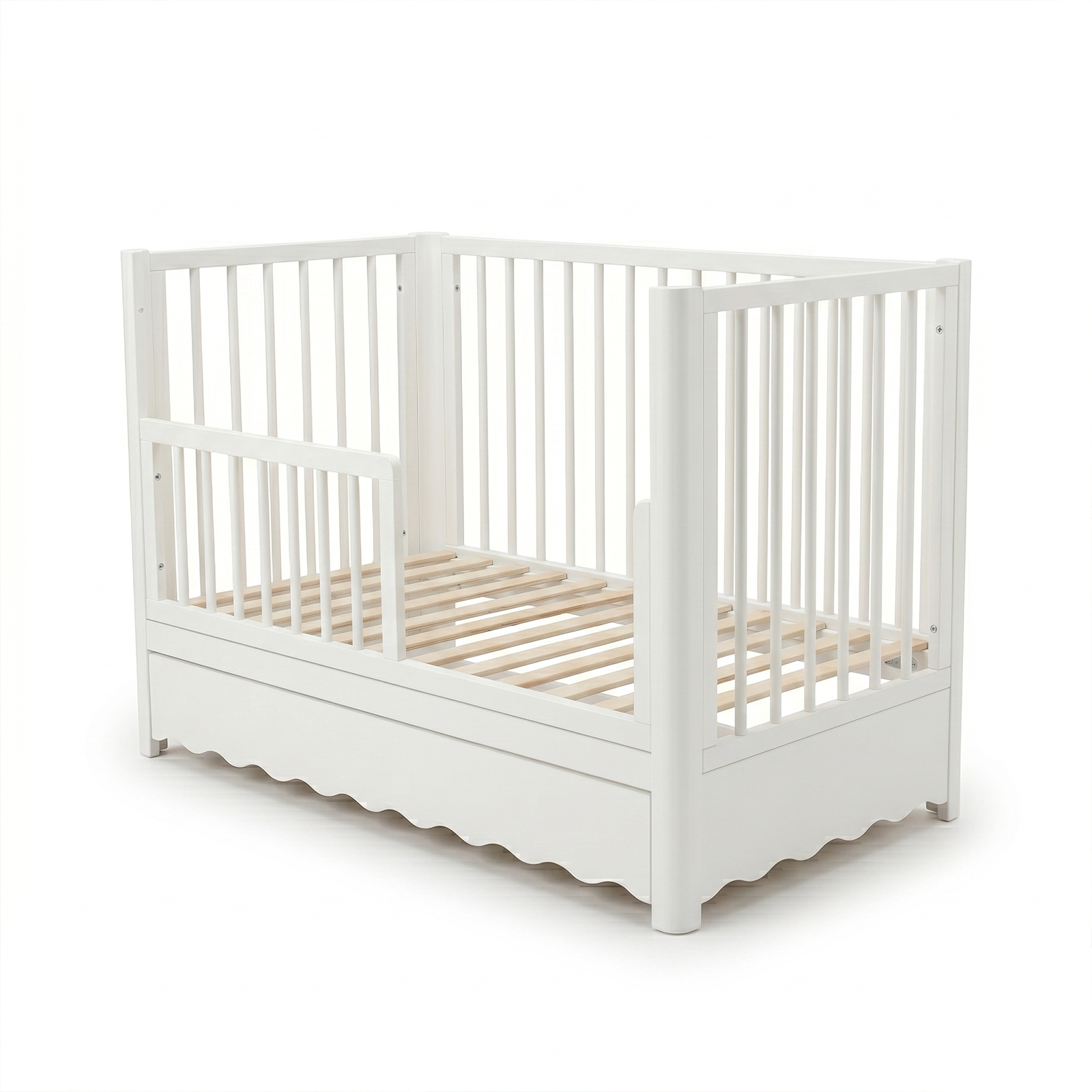Full view of white baby crib with storage drawer on white background