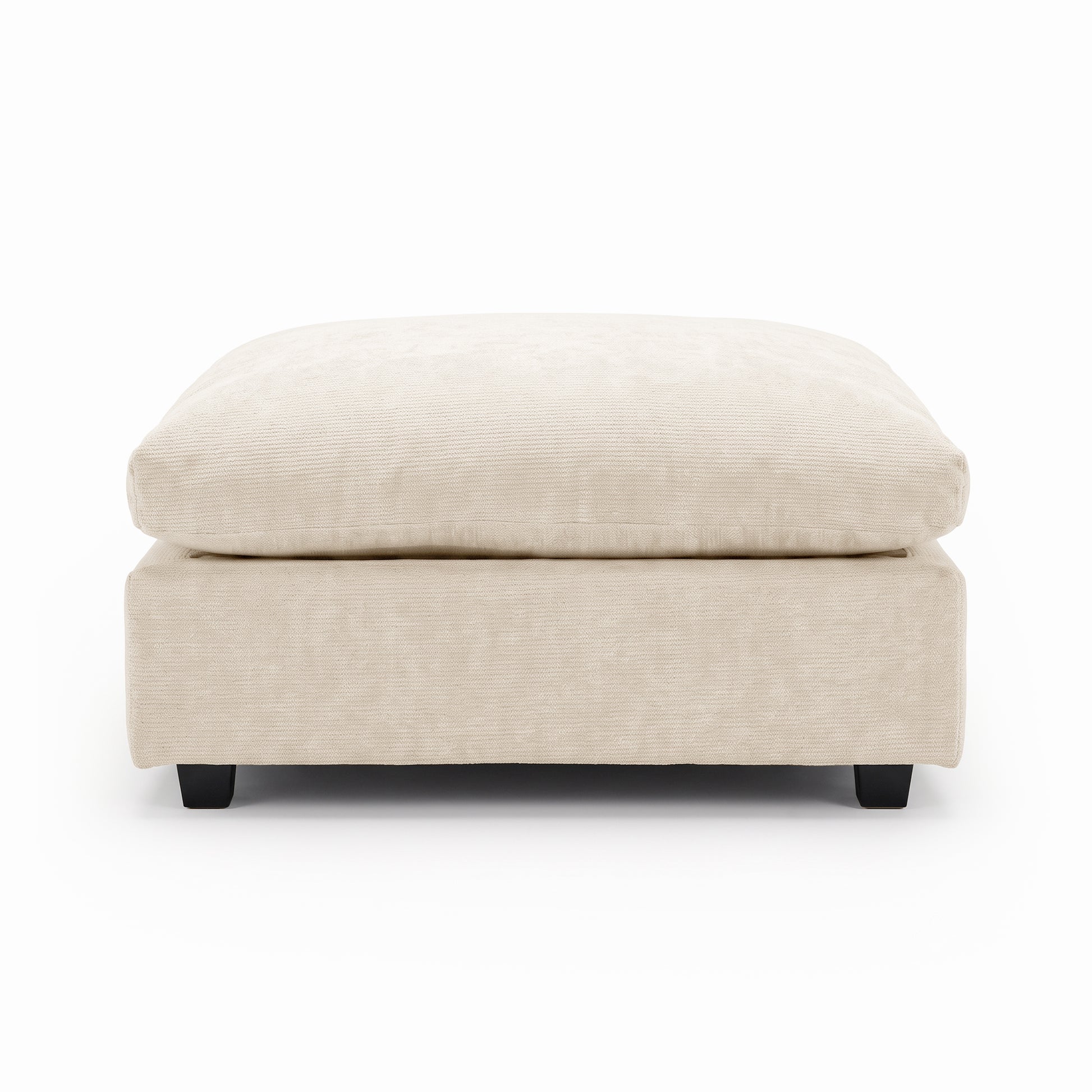 Rectangular beige upholstered ottoman on a white background