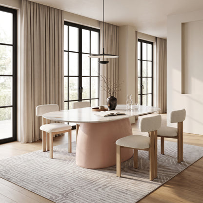 Modern oval dining table styled in a contemporary dining room with chairs and decor