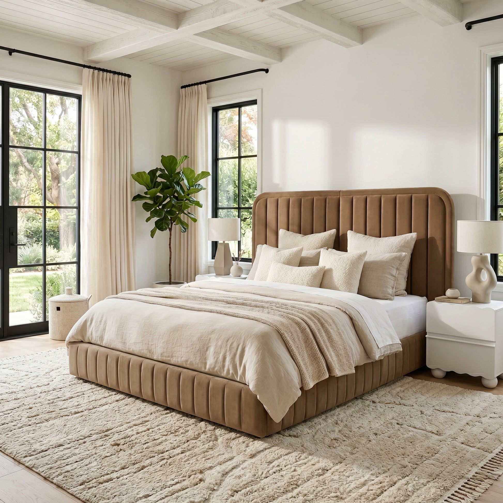 Lifestyle shot of upholstered bed in bright bedroom with windows, nightstands and plant