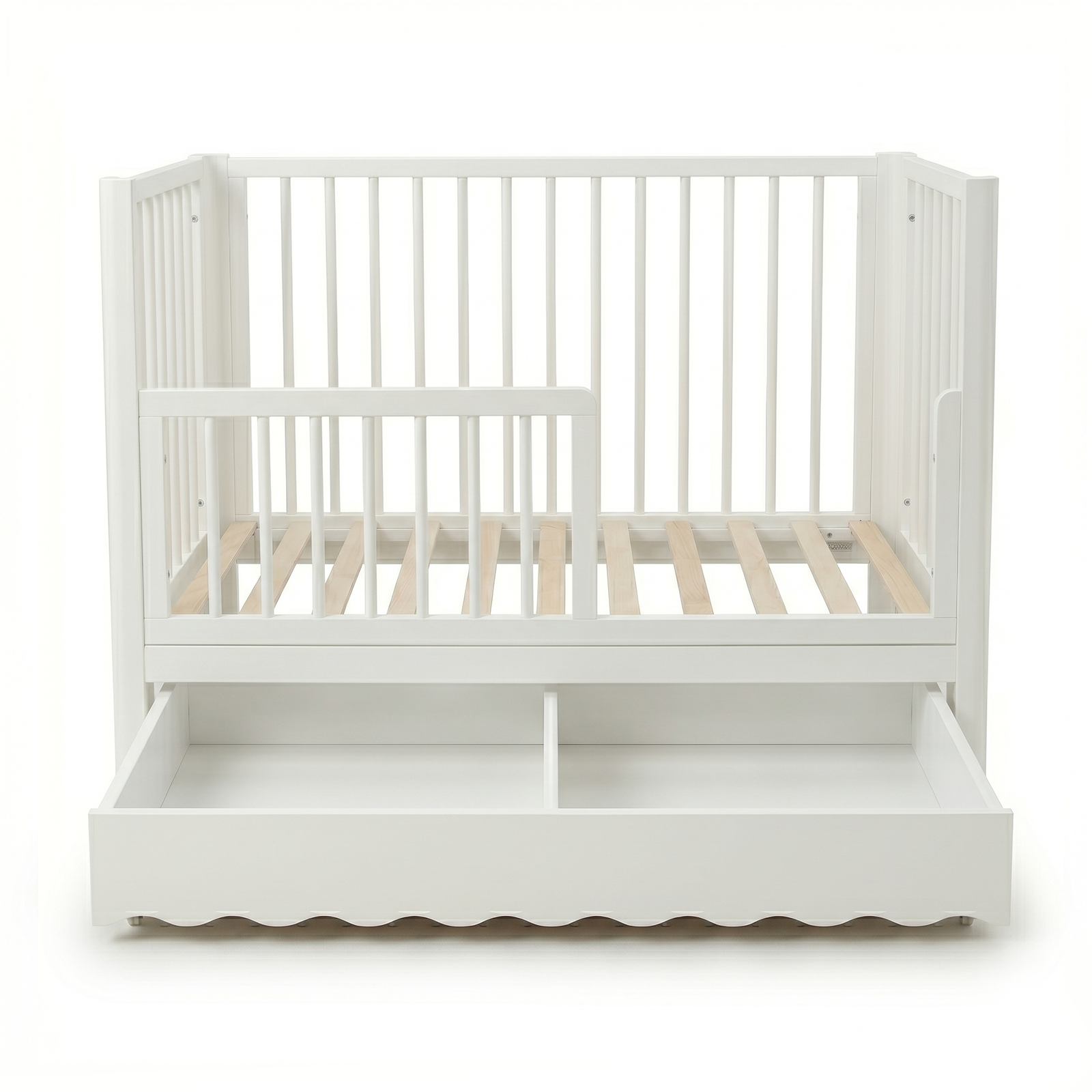 White convertible baby crib with underbed storage drawer on white background