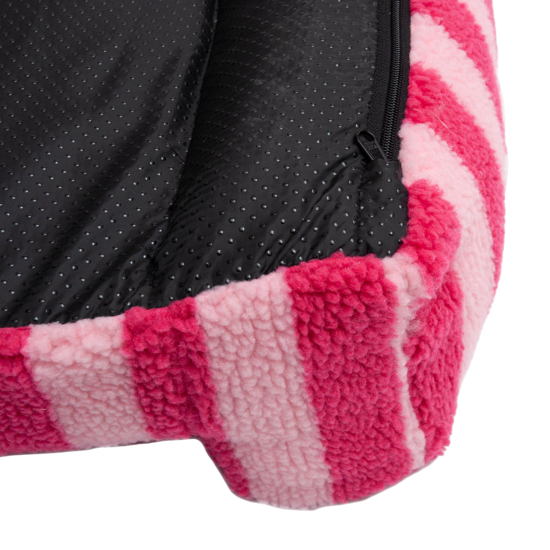 Close-up of pink striped fleece fabric and zipper detail on a white background