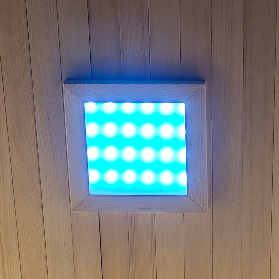 Square LED ceiling light mounted on a wooden plank ceiling.