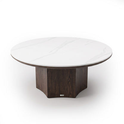 Round coffee table with a marble-look top and dark wooden pedestal base on a white background