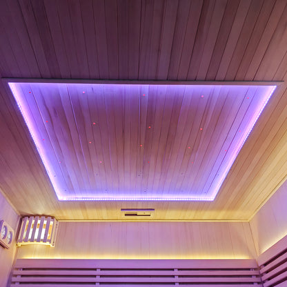 Wooden sauna ceiling and upper walls with purple and yellow LED lighting
