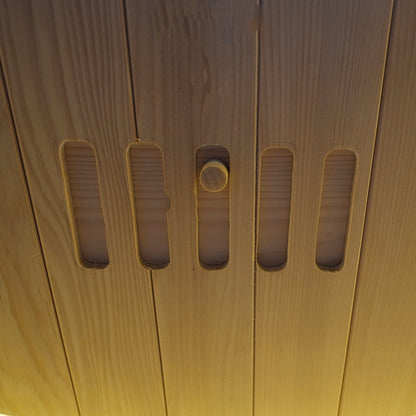 Close-up detail of a wooden surface with vertical slots and a knob