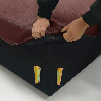 Hands lifting cover corner of mattress or furniture base to reveal inner structure