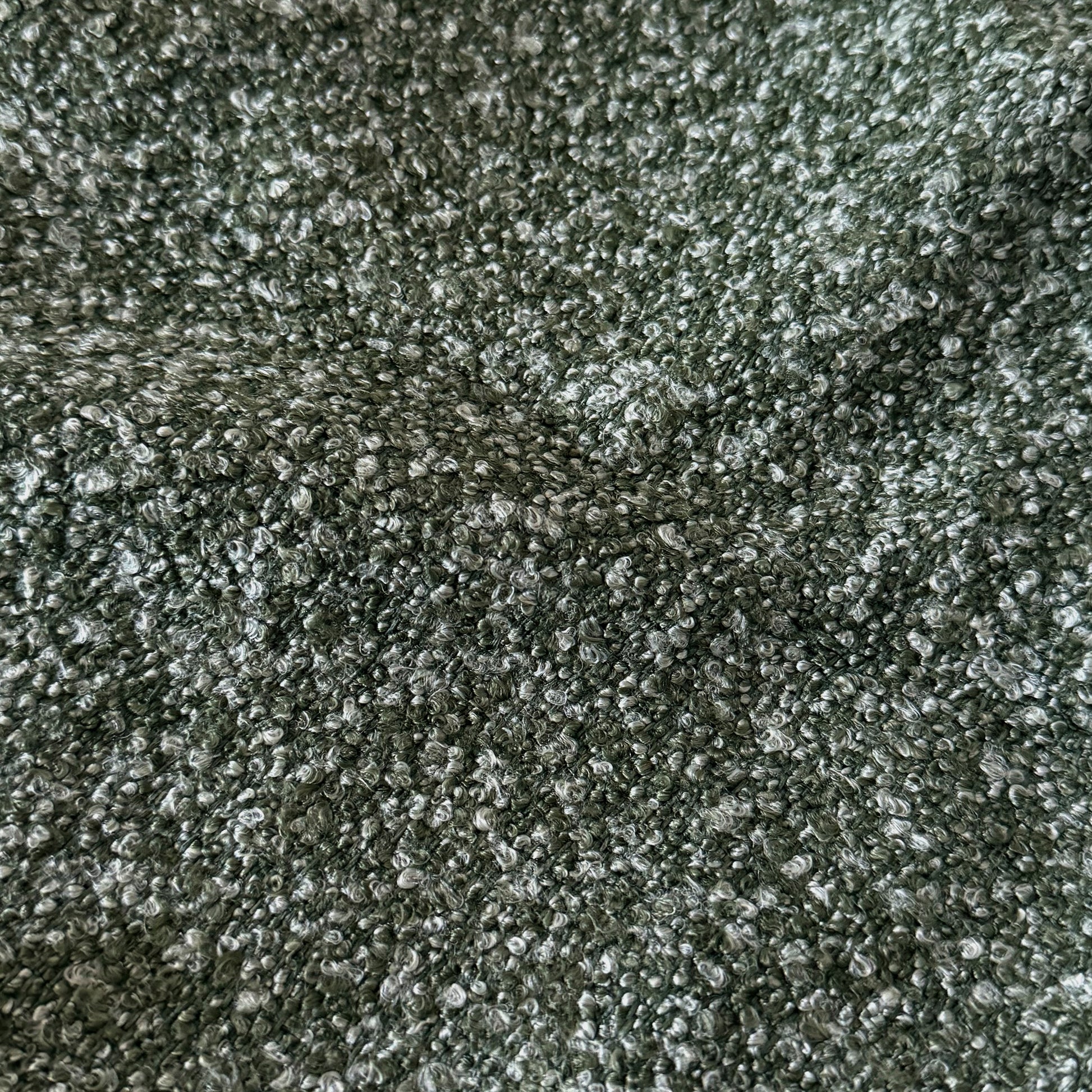 Extreme close-up of green boucle fabric texture