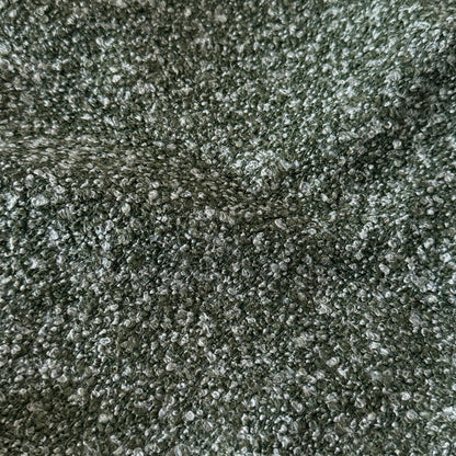 Extreme close-up of green boucle fabric texture