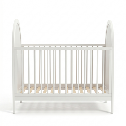 Symmetrical front view of white crib with arched sides and evenly spaced slats