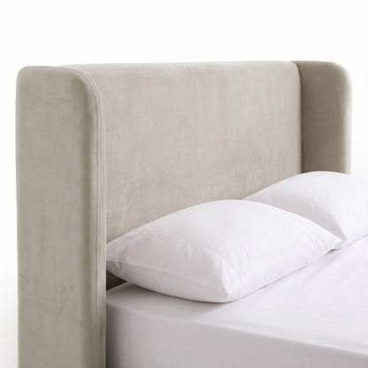 Close view of upholstered headboard and upper bed area on white background