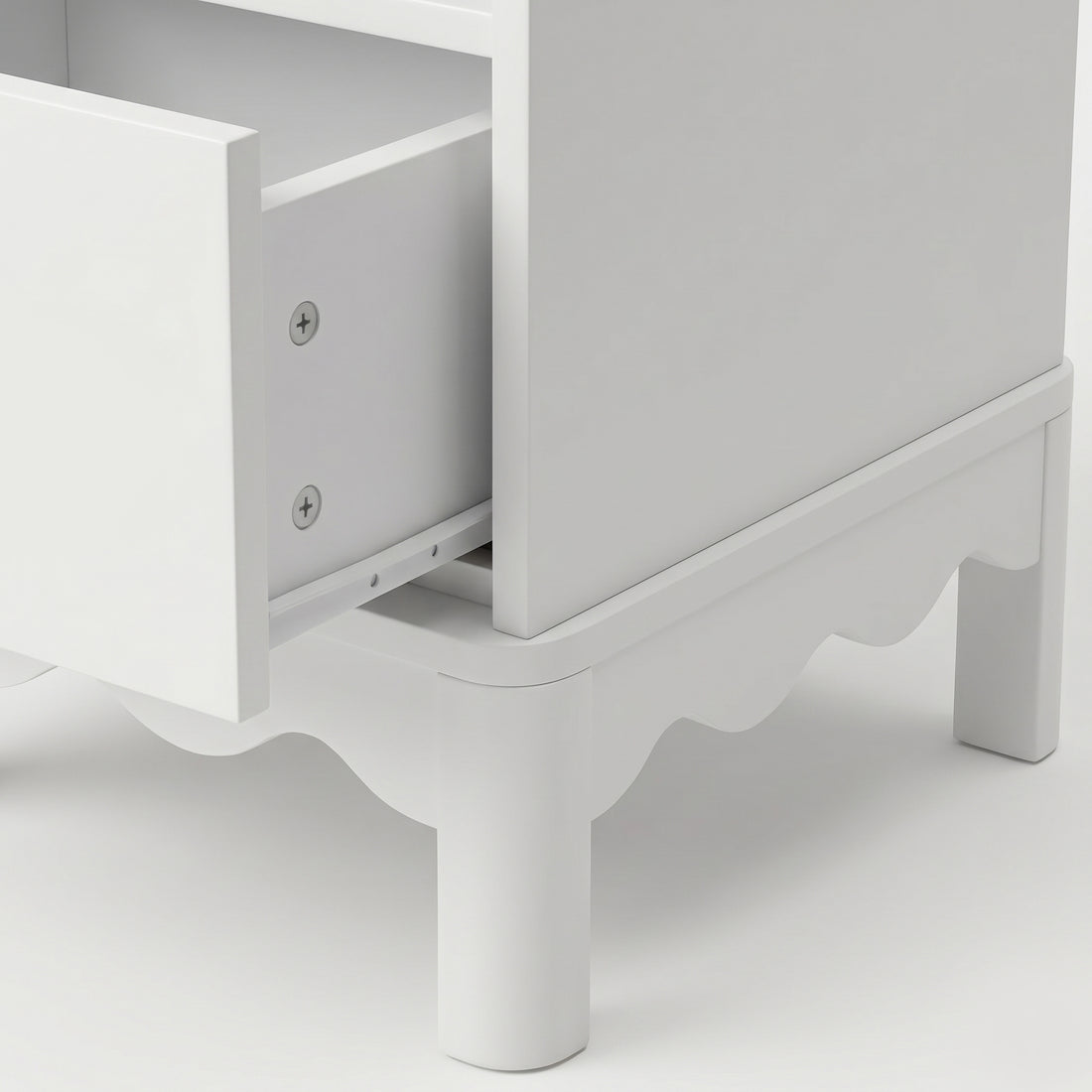 Close-up of an open drawer on white dresser