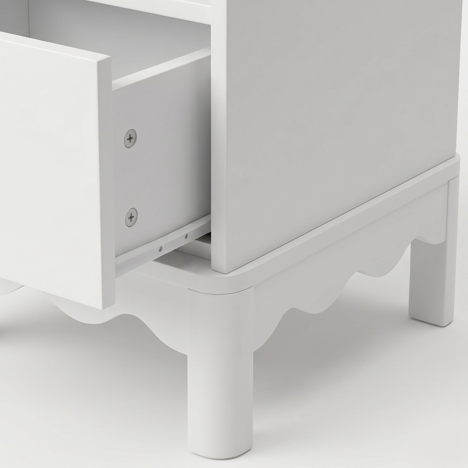 Close-up of an open drawer on white dresser