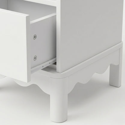 Close-up of an open drawer on white dresser