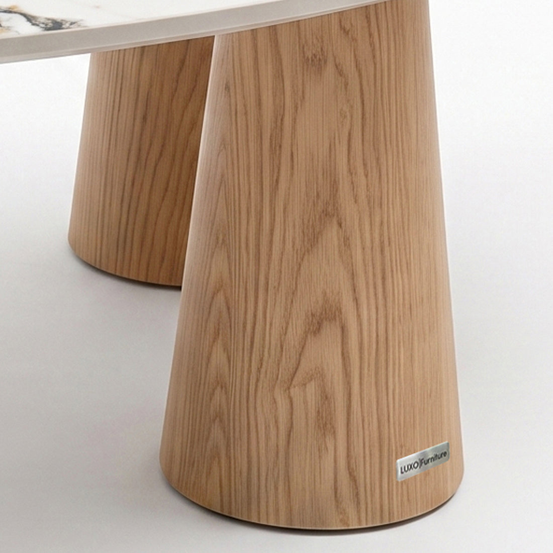 Close-up of a wooden table base and tabletop edge on a neutral background