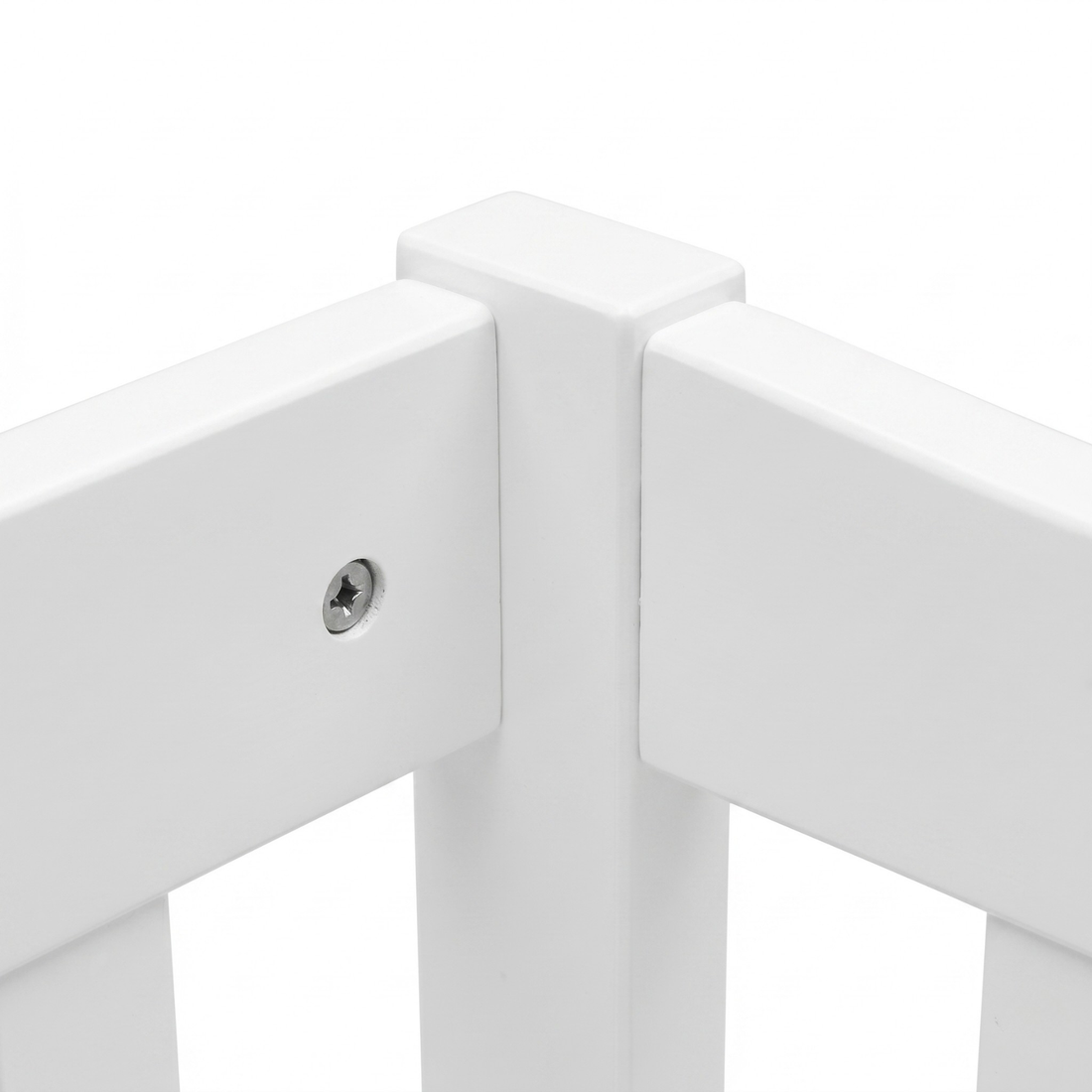 Close-up of a white furniture corner joint with screw detail