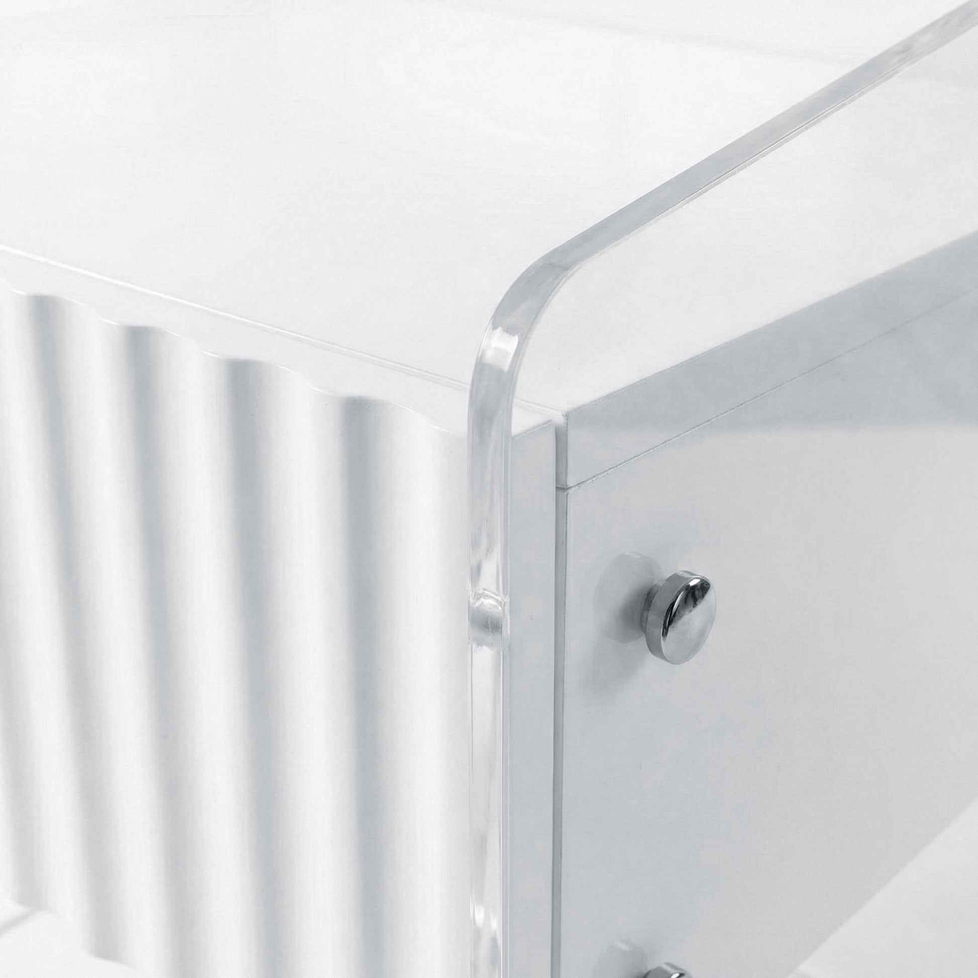 Corner detail of acrylic furniture showing ribbed panel and knob
