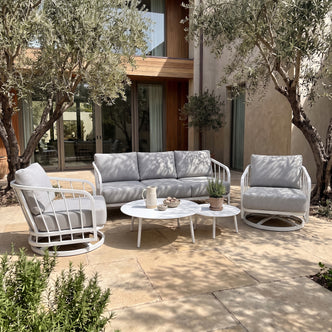 Outdoor patio furniture set staged in a garden setting