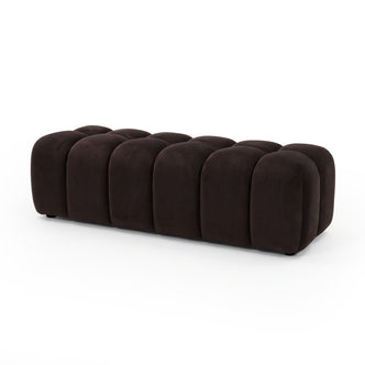 Chocolate brown velvet upholstered ottoman bench on a white background shown in full.