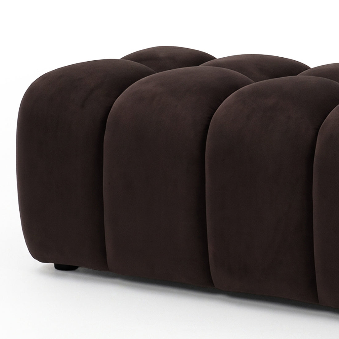 Chocolate brown tufted ottoman bench on a white background, slightly cropped.