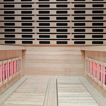Interior view of a wooden sauna with benches and illuminated heating panels